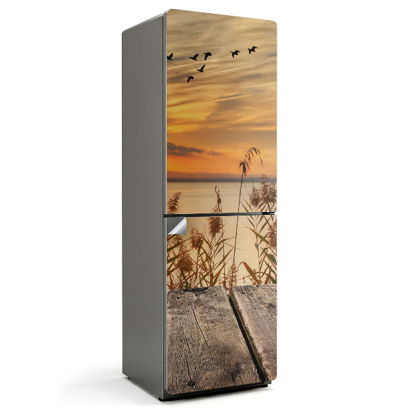 Naklejka na lodówkę Zachód słońca nad wodą