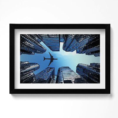 Obraz w ramie Samolot nad budynkami